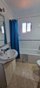a bathroom with a sink and a tub and a toilet at Tres Playas Apartment in Puerto de Mazarrón