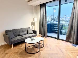 a living room with a couch and a table at Luxe 1br apartment on Park in Cape Town