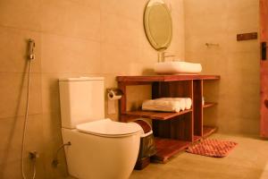 a bathroom with a toilet and a sink and a mirror at Rams Resort in Arugam Bay +160 photos