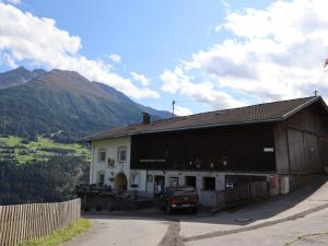 a barn with a truck parked in front of it at Gmarerhof in Grins +7 photos