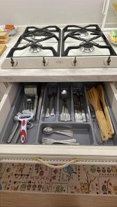 a stove top in a drawer in a kitchen at Casa del Mare in Livorno