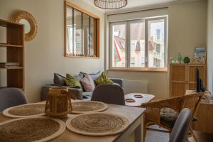a living room with a table and chairs at Appartement Le Fayot in Wimereux