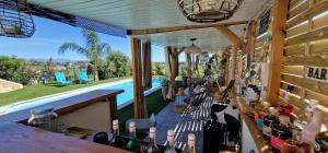 a bar with a lot of bottles of wine at Villa Bistinetti Rez de villa tout confort avec piscine in Penta-di-Casinca