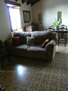a woman laying on a couch in a living room at Casa Domi in La Esperanza