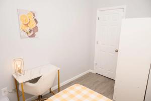 a white room with a desk and a chair at Beachh - 2Beach House - Yellow3090 in Brooklyn