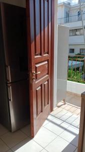 an open wooden door with a view of a building at Adorable apartment in Athens +43 photos