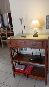 a desk with a lamp on top of it at Adorable apartment in Athens
