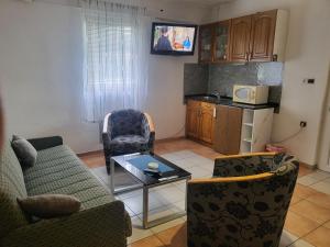 a living room with a couch and chairs and a table at HOSTEL "ARCO" in Brčko