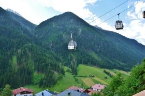 a couple of ski lifts flying over a mountain at Haus Tschiderer in Kappl