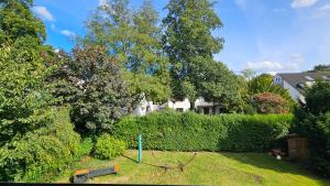 a yard with a swing set in the grass at Quartier Levi in Oberhausen