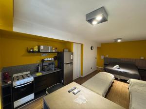 a small room with two beds and a kitchen at Apart Tonico in Buenos Aires
