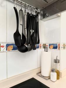 a kitchen with utensils hanging on the wall at A Gandarela in Ribadavia +16 photos