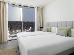 a bedroom with a large white bed and a balcony at Villa Deluxe 1&2 - Casangular by Upper in Adeje +13 photos