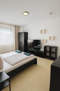a bedroom with a large bed and a couch at Helle 2-Zimmer Erdgeschosswohnung mit Terrasse in Koblenz