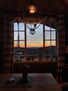 Zimmer mit einem Fenster und Blick auf den Sonnenuntergang in der Unterkunft Traditional cabin at Norefjell in Surteberg
