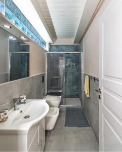 a bathroom with a sink and a toilet and a shower at Holiday Suite Versilia in Viareggio