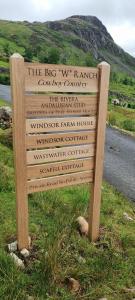 a sign in the grass next to a road at Windsor Farm House on The Big "W" Ranch in Nether Wasdale