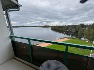 a view of a lake from a balcony at Hotelli Terme, huone 617 in Ikaalinen