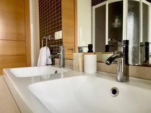 a bathroom with a white sink and a mirror at A Gandarela in Ribadavia