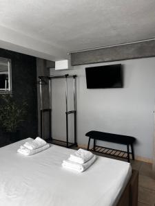a bedroom with a bed with two towels on it at TheLoft Apartment in Kavála