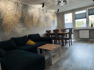 a living room with a couch and a table at Belle Apartament in Krapkowice