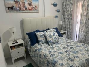 - une chambre avec un lit doté de draps et d'oreillers bleus et blancs dans l'établissement Precioso dúplex con piscina, en 1ª linea de playa, à Puerto de Mazarrón 72 autres photos