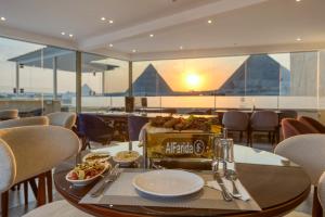 a restaurant with a table with food on it at AL Farida Boutique Pyramids in Cairo
