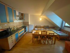 a kitchen and dining room with a table and chairs at Apartmán Alva 3 in Mikulov +18 photos