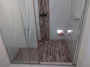 a shower with a glass door in a bathroom at Chez Lolah in Antsiranana +9 photos