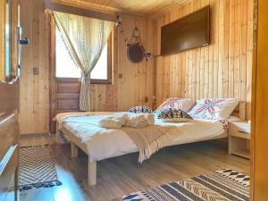 a bedroom with a bed in a wooden room at La Sava lui Traian in Gârda de Sus