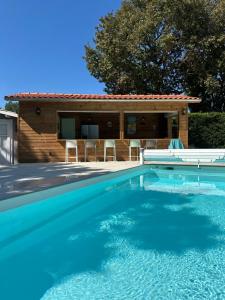 a swimming pool in front of a house at Villa Gainsbourg in Andernos-les-Bains