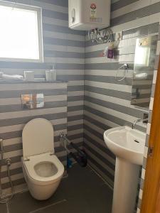 a bathroom with a toilet and a sink at Madhu's stay in Dehradun