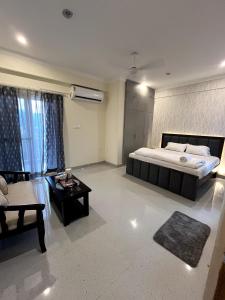 a large bedroom with a bed and a table at Madhu's stay in Dehradun