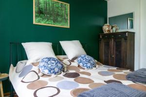 a bedroom with a bed with two pillows on it at Willa Antonina in Supraśl