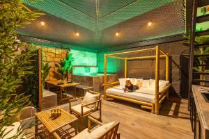 a woman sitting on a bed in a room at INTENSE Senses Experience - Suites wellness avec piscine, jacuzzi, sauna, billard etc in Manage +38 photos