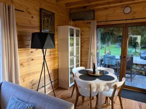 a living room with a table and a couch at Domek pod świerkiem in Tereszpol Zaorenda
