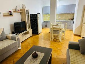 a living room with a couch and a table and a kitchen at Spacious Coastal Retreat - Golem Beach Near Durrës in Golem