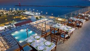 a balcony with tables and chairs and a view of the ocean at فندق النزهه in Cairo