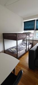 two bunk beds in a room with a table at 2 Room Apartment in Randers C in Randers