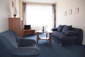 a living room with a couch and a table at ELPAK Świnoujście in Świnoujście