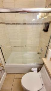 a bathroom with a toilet and a glass shower at Quiant 2 Bedroom Suite in Vancouver +22 photos