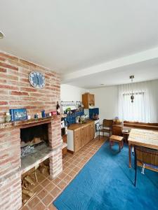 a living room with a brick fireplace and a kitchen at Apartmán u Čertova mlýna Zelezna Ruda in Špičák +35 photos