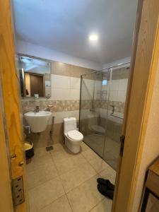 a bathroom with a toilet and a sink and a shower at Kazani Heights Luxurious apartments in Islamabad