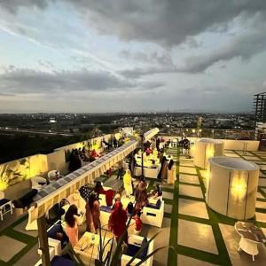 a group of people sitting on the roof of a building at Kazani Heights Luxurious apartments in Islamabad +19 photos