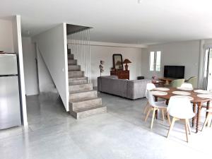 una cucina e una sala da pranzo con tavolo e scala di Maison Le Vergey Cadillac a Cadillac