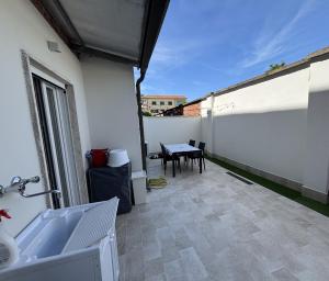 a view of a patio with a table on a building at Casa Milele in Viareggio