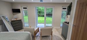 a dining room with a table and chairs and a window at Breagha Cabin, Spean Bridge, near Fort William in Spean Bridge