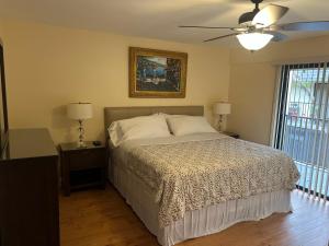 a bedroom with a bed and a ceiling fan at Very nice 2 bedroom 2 bath Condo in Deerfield Beach