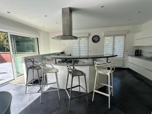 a kitchen with a island with bar stools at Le Jardin Minelle in Arras