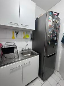 a kitchen with a stainless steel refrigerator and a sink at Preciosa vista Viña - San Martin 10 Norte in Viña del Mar